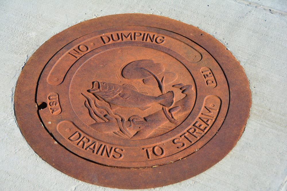 Drain cover with embossed marker