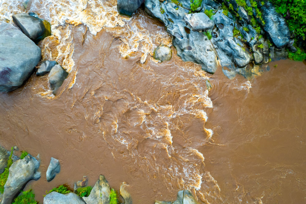 Aerial photograph of highly turbid water in river.