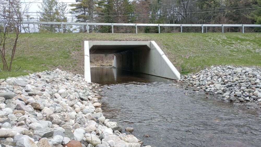 A large concrete box culvert under a roadway.