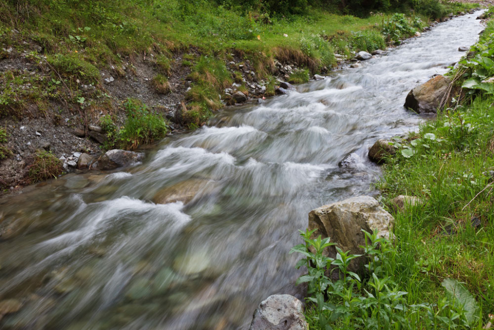A small mountain river with raging flow.