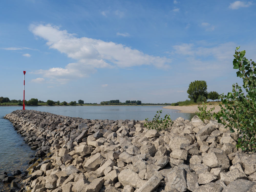 Riprap wake barrier on river.