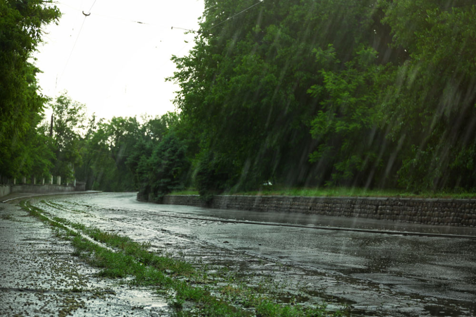 Heavy rainfall hitting city street.