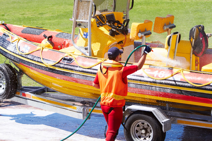 Motorboat being washed on trailer